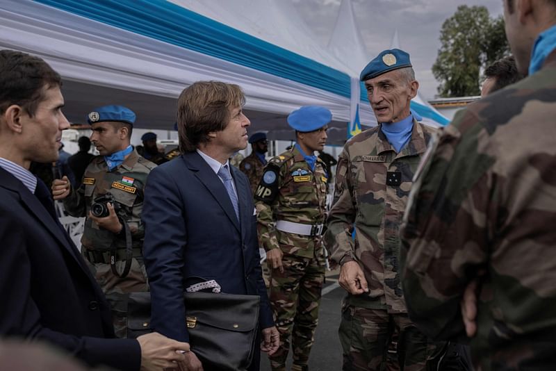 Nicolas de Rivière (3rd L), Permanent Representative of France to the United Nations, United Nations Organization Stabilization Mission in the Democratic Republic of the Congo (MONUSCO), speaks with peacekeepers during a ceremony in honour of peacekeepers killed in the line of duty since the mission began, in Goma on 11 March 2023.