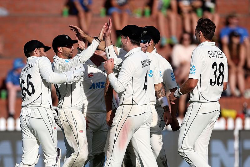 New Zealand players celebrate Sri Lanka's captain Dimuth Karunaratne being caught on day three of the second Test between New Zealand and Sri Lanka at the Basin Reserve in Wellington on 19 March 2023