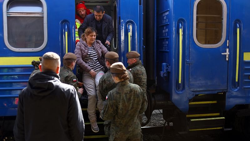 Ukrainian refugees disembark a train from Odesa at Przemysl Glowny train station, after fleeing the Russian invasion of Ukraine, in Przemysl, Poland, 27 March 2022