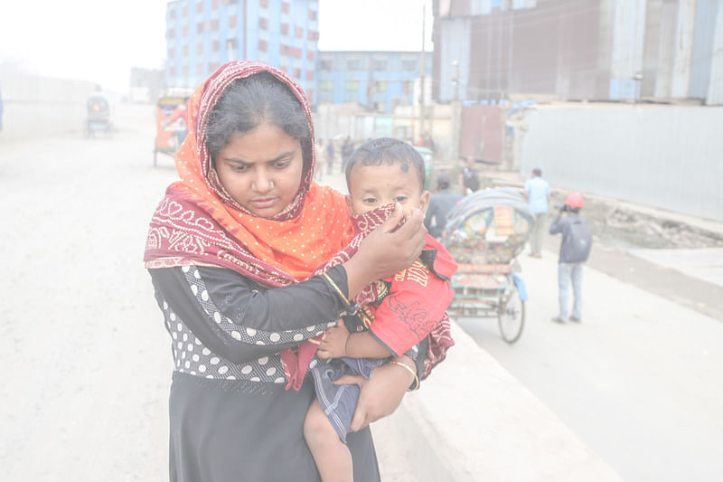 A woman tries to saver her child from inhaling polluted air