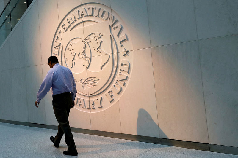 A man walks past the International Monetary Fund (IMF) logo at its headquarters in Washington, US, 10 May 2018.