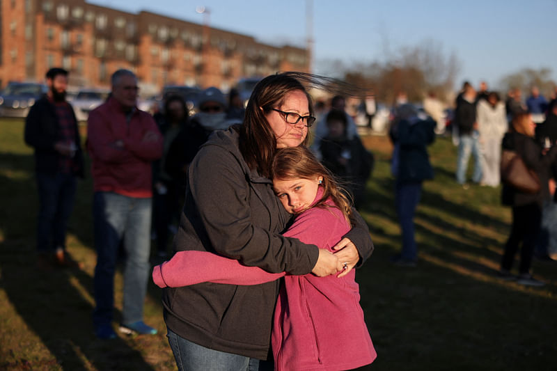 Sarah Tuck holds her daughter Emmalin Sweeney, 10, during a vigil in Mt. Juliet, held for the victims of a deadly shooting at the Covenant School in Nashville, Tennessee, U.S., March 28, 2023.