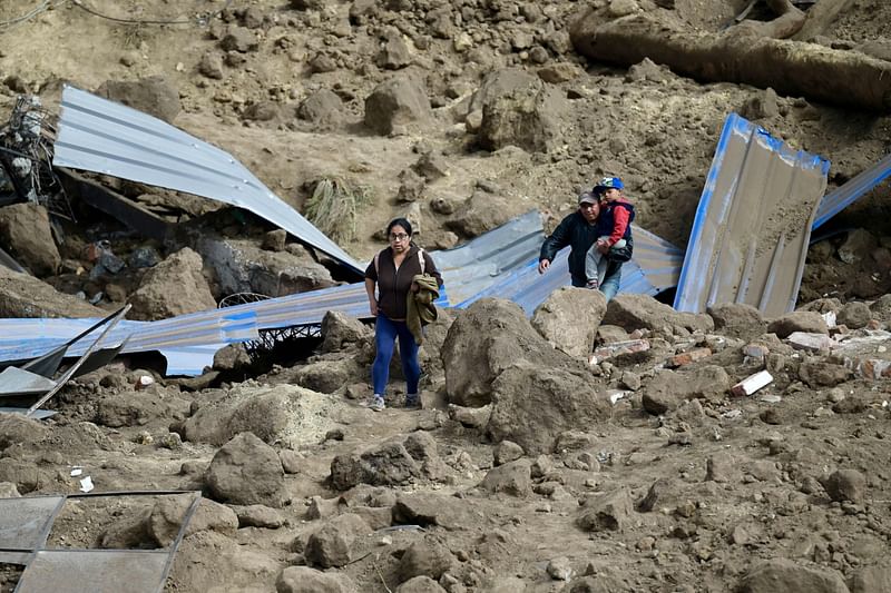 Residents abandon their homes after a landslide in Alausi, Ecuador on 28 March, 2023