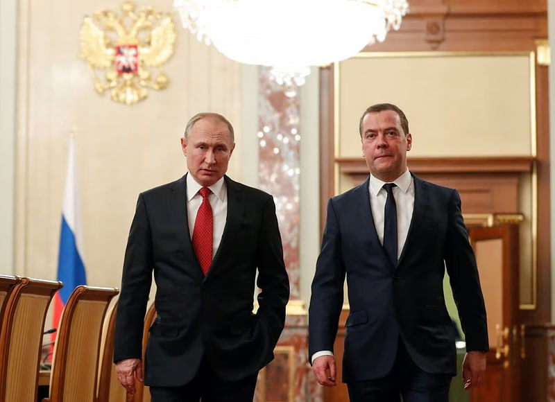 Russian president Vladimir Putin and prime minister Dmitry Medvedev speak before a meeting with members of the government in Moscow, Russia on 15 January, 2020.