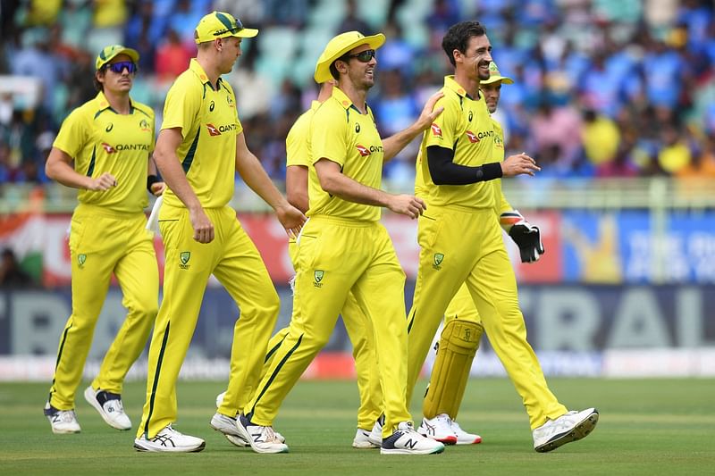 Australia's Mitchell Starc celebrates with teammates after the dismissal of India's captain Rohit Sharma during the 2nd ODI between India and Australia at the Y.S. Rajasekhara Reddy Cricket Stadium in Visakhapatnam on 19 March 2023