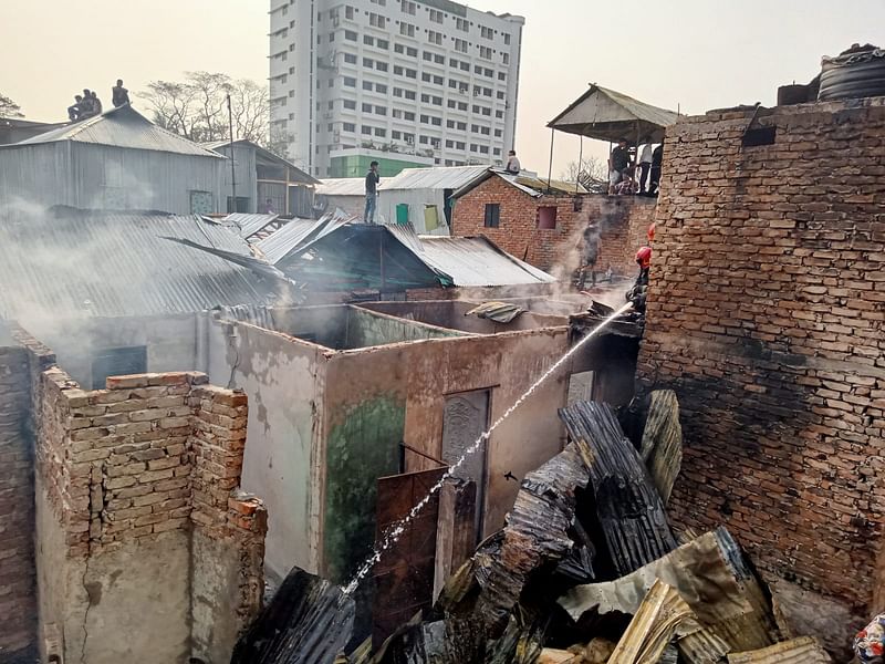 Firefighters douse fire at the Shattola slum in Dhaka’s Mohakhali area early Monday.