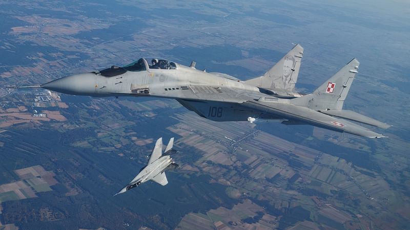 This file photo taken on 12 October, 2022 shows two MiG 29 fighter jets taking part in the NATO Air Shielding exercise near the air base in Lask, central Poland