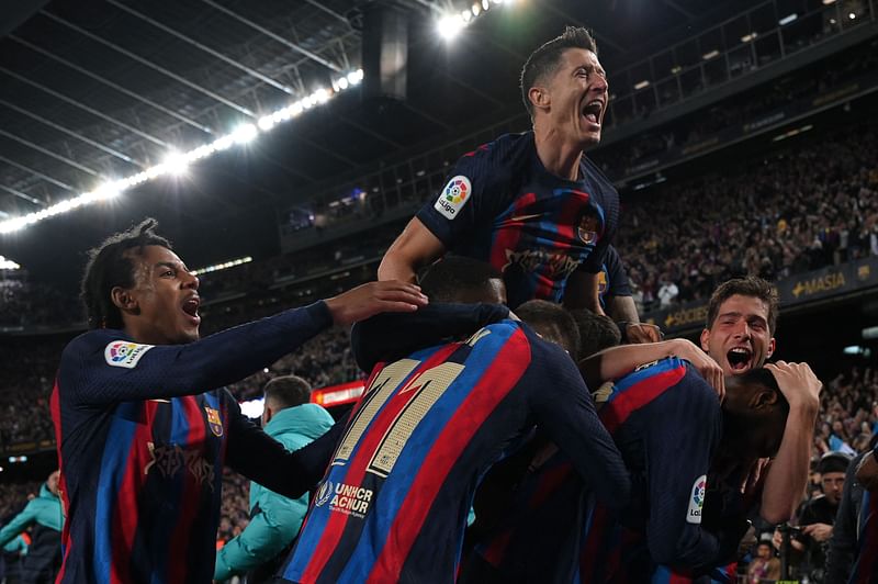 Barcelona's Ivorian midfielder Franck Kessie celebrates with teammates after scoring his team's second goal during the Spanish league football match between FC Barcelona and Real Madrid CF at the Camp Nou stadium in Barcelona on 19 March, 2023