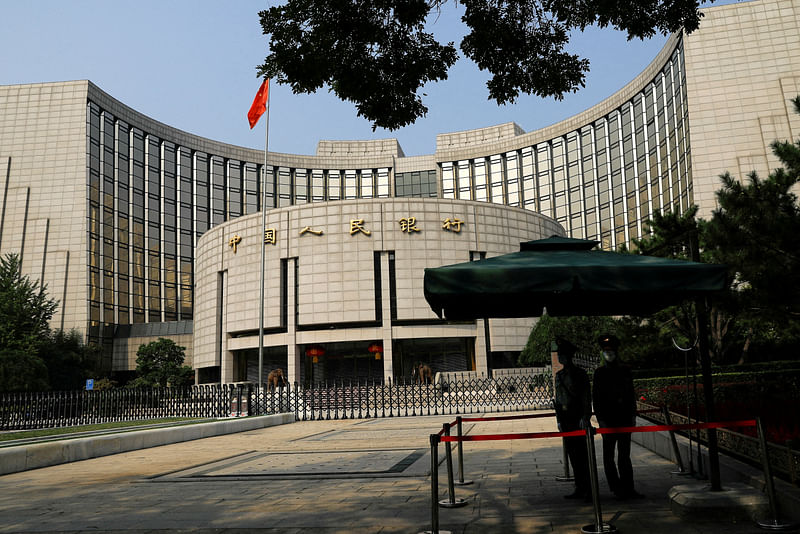 Paramilitary police officers stand guard in front of the headquarters of the People's Bank of China, the central bank (PBOC), in Beijing, China September 30, 2022