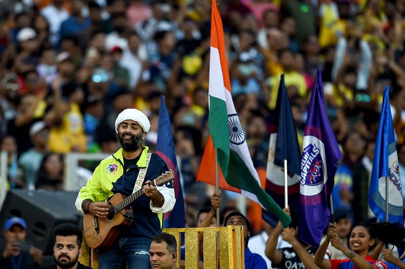 Bollywood singer Arijit Singh (L) performs for the opening ceremony before the start of first match of the Indian Premier League (IPL) Twenty20 cricket match between Gujarat Titans and Chennai Super Kings at the Narendra Modi Stadium in Ahmedabad on 31 March, 2023.