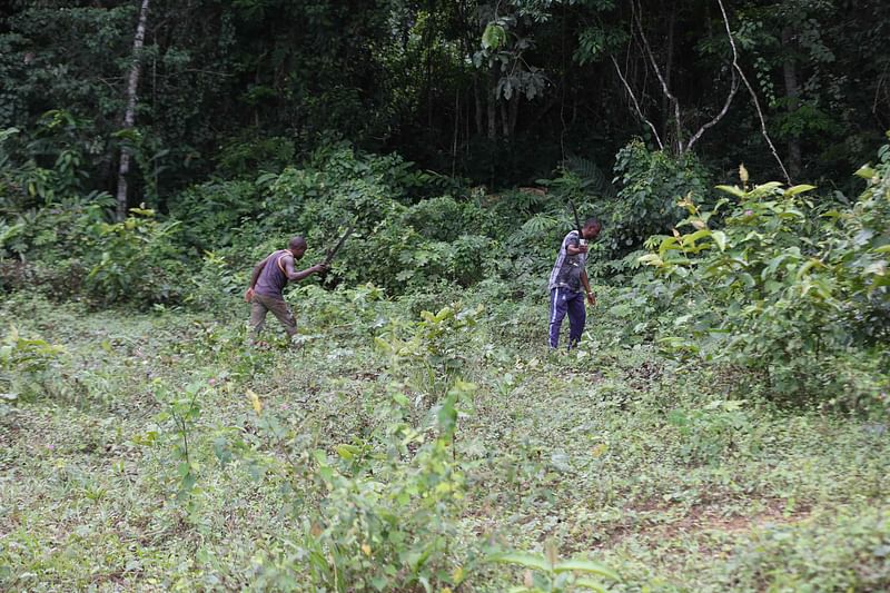 Arsène Ibaho (R) searches for the old tombs of the village without success after they were destroyed by the bulldozers of the foresters near Makokou on 14 February, 2023