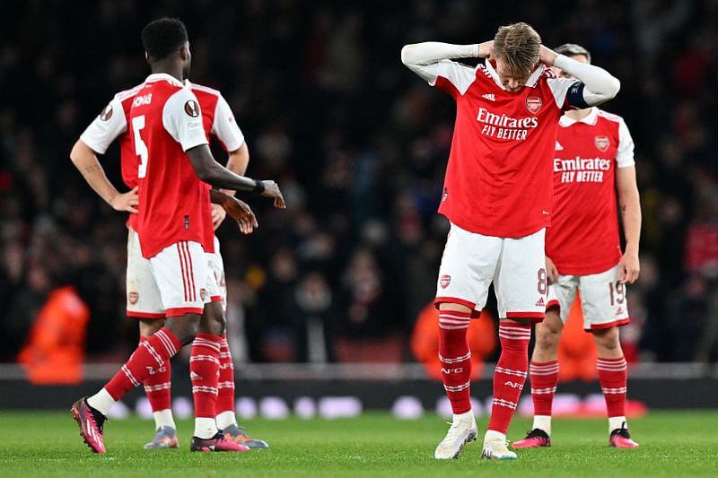 Arsenal's Norwegian midfielder Martin Odegaard and teammates react after a penalty shoot-out in the UEFA Europa League round of 16, second-leg match between Arsenal and Sporting Lisbon at the Emirates Stadium in London on 16 March 2023. Sporting Lisbon won the match 5-3 on penalties