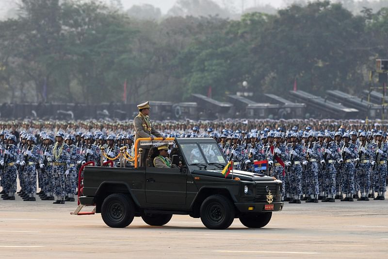 Myanmar's Chief Senior General Min Aung Hlaing stands in a vehicle as he attends a ceremony to mark the country's 78th Armed Forces Day in Naypyidaw on 27 March, 2023.