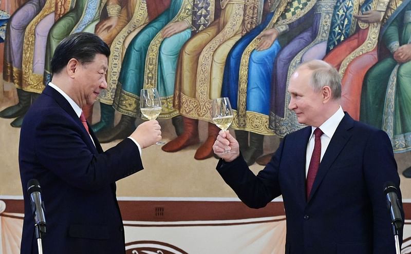 Russian President Vladimir Putin and China’s President Xi Jinping make a toast during a reception following their talks at the Kremlin in Moscow on 21 March, 2023