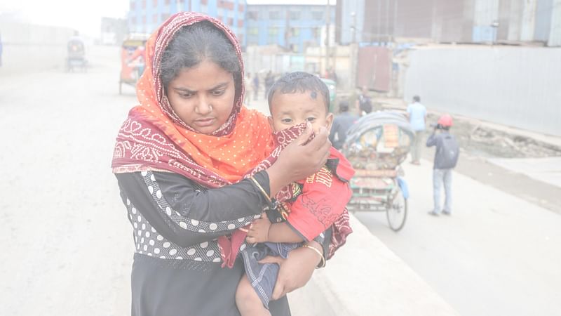 A woman tries to saver her child from inhaling polluted air