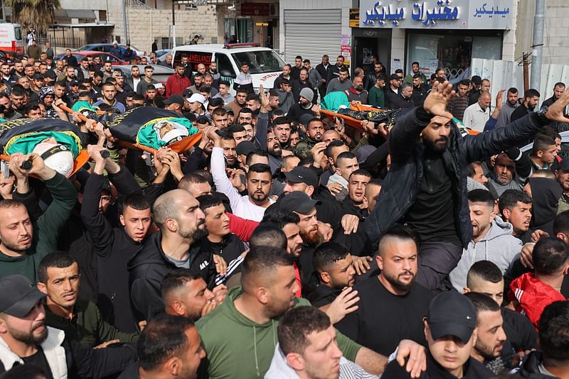 Mourners carry bodies wrapped with the flag of Palestinian militant group Islamic Jihad, after three Palestinians were shot dead by Israeli border police in in the occupied West Bank on 9 March, 2023