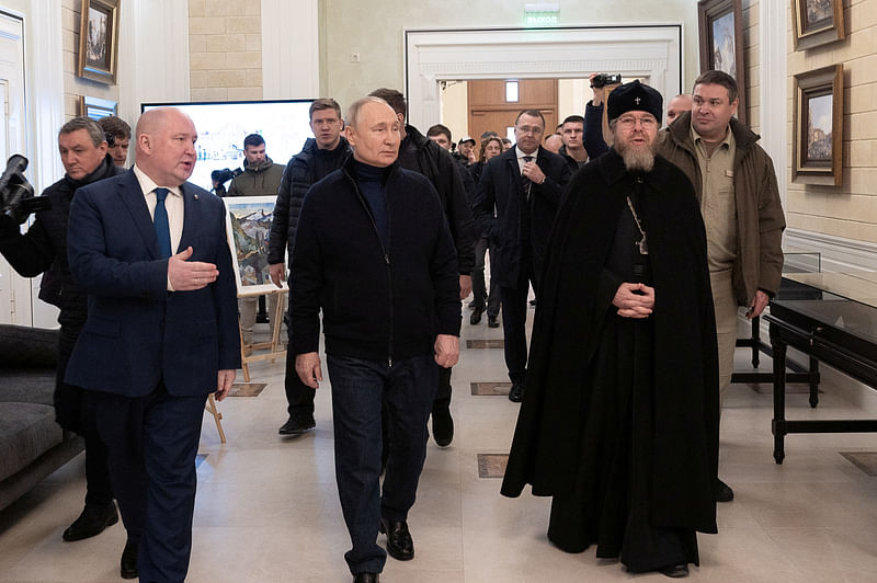 Russian President Vladimir Putin, accompanied by Governor of Sevastopol Mikhail Razvozhayev and Metropolitan Tikhon (Shevkunov), chairman of the Patriarchal Council for Culture, visits a children’s arts and aesthetic centre in Sevastopol, Crimea on 18 March, 2023