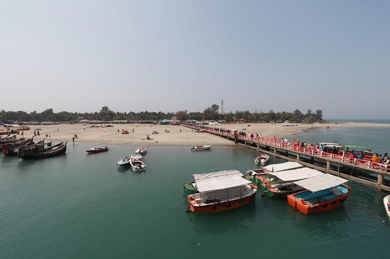 Tourists cross the jetty on St Martin’s Island on 26 February 2023.