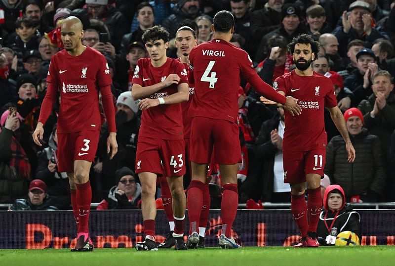 Liverpool's Egyptian striker Mohamed Salah (R) celebrates scoring the team's second goal during the English Premier League football match between Liverpool and Wolverhampton at Anfield in Liverpool, north west England on 1 March, 2023.