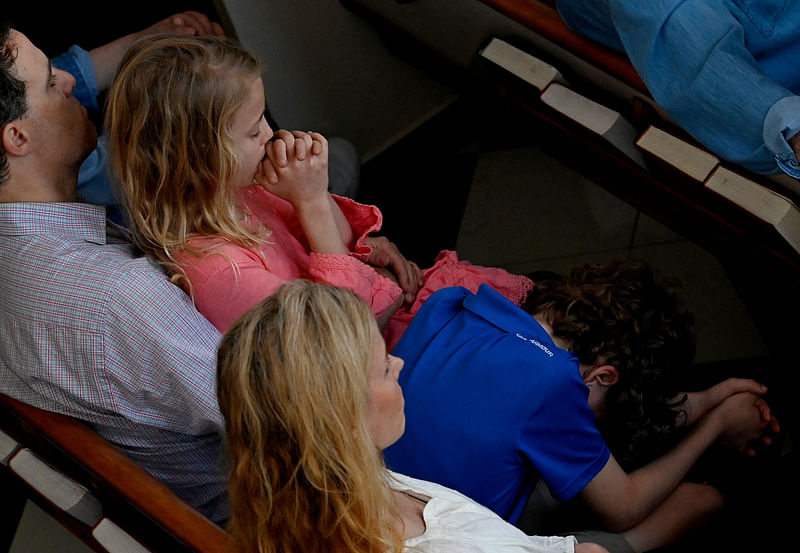 Family members pray during a vigil at Woodmont Christian Church for victims of the mass shooting at Covenant School in Nashville, Tennessee, U.S. March 27, 2023.