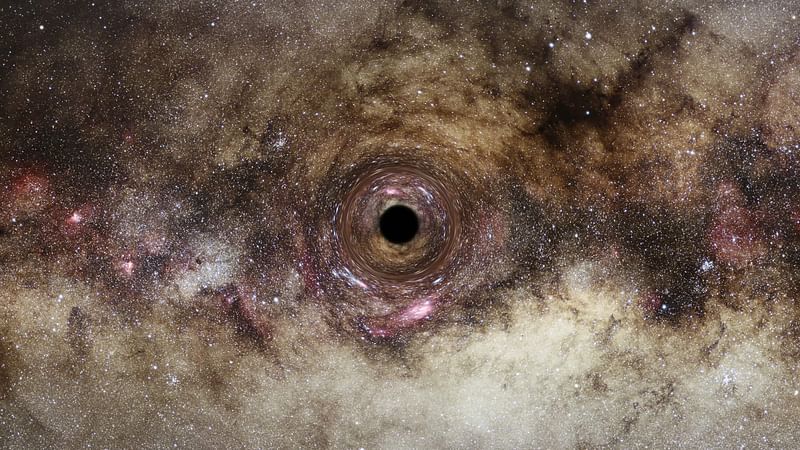 This handout image released on 10 June, 2022 by ESA Hubble, shows an artist’s impression of a black hole in the Milky Way galaxy, which distorts light passing near it creating a phenomenon known as gravitational lensing