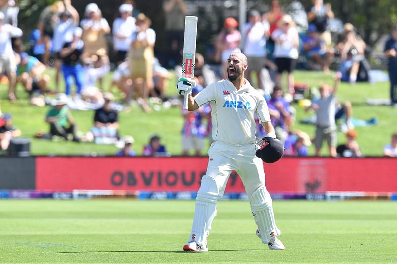 New Zealand's Daryl Mitchell celebrates after scoring 100 runs during the third day of the first Test cricket match between New Zealand and Sri Lanka at Hagley Oval in Christchurch on March 11, 2023