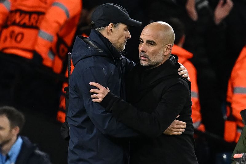 Bayern Munich's German head coach Thomas Tuchel and Manchester City's Spanish manager Pep Guardiola embrace after the UEFA Champions League quarter final, first leg match between Manchester City and Bayern Munich at the Etihad Stadium in Manchester, north-west England on 11 April 2023