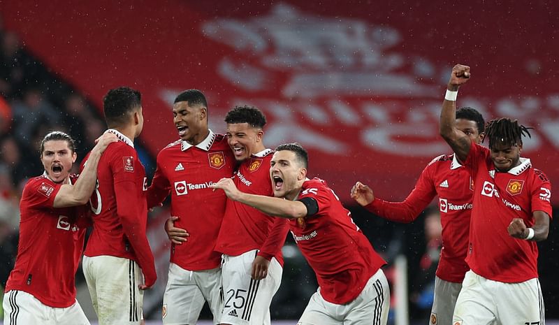 Manchester United's Austrian midfielder Marcel Sabitzer (L), Manchester United's Brazilian midfielder Casemiro (2L), Manchester United's English striker Marcus Rashford (3L), Manchester United's English striker Jadon Sancho (C), Manchester United's Portuguese defender Diogo Dalot (3R) and Manchester United's Brazilian midfielder Fred (R) celebrate after winning a penalty shoot out during the English FA Cup semi-final football match between Manchester United and Brighton and Hove Albion at Wembley Stadium in north west London on 23 April, 2023