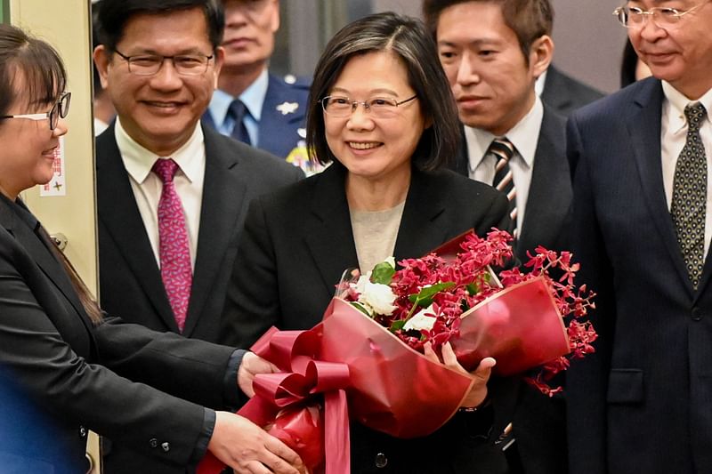 Taiwan's President Tsai Ing-wen receives flowers upon her arrival at the Taoyuan International Airport on 7 April 2023.