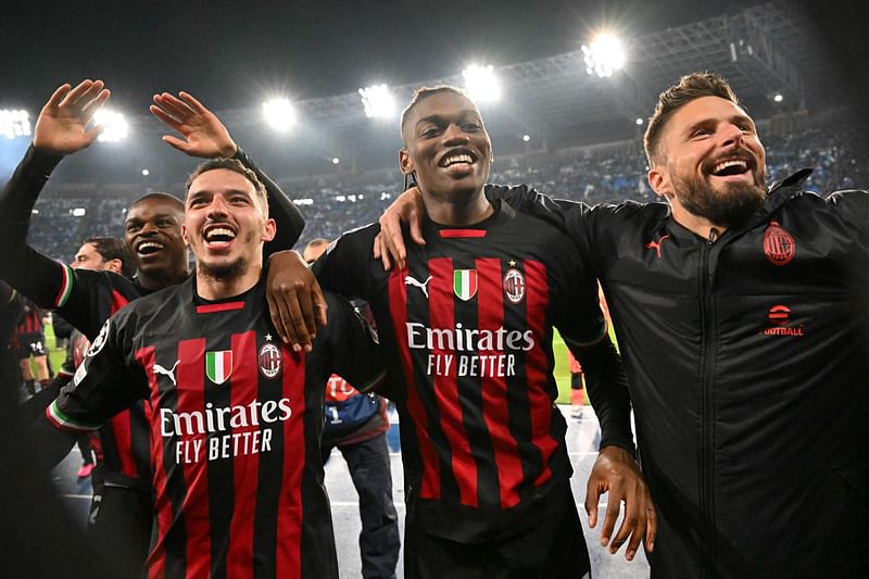 AC Milan's French defender Pierre Kalulu, Algerian defender Ismael Bennacer, Portuguese forward Rafael Leao and French forward Olivier Giroud celebrate at the end of the UEFA Champions League quarter-finals second leg match between SSC Napoli and AC Milan on 18 April 2023 at the Diego-Maradona stadium in Naples