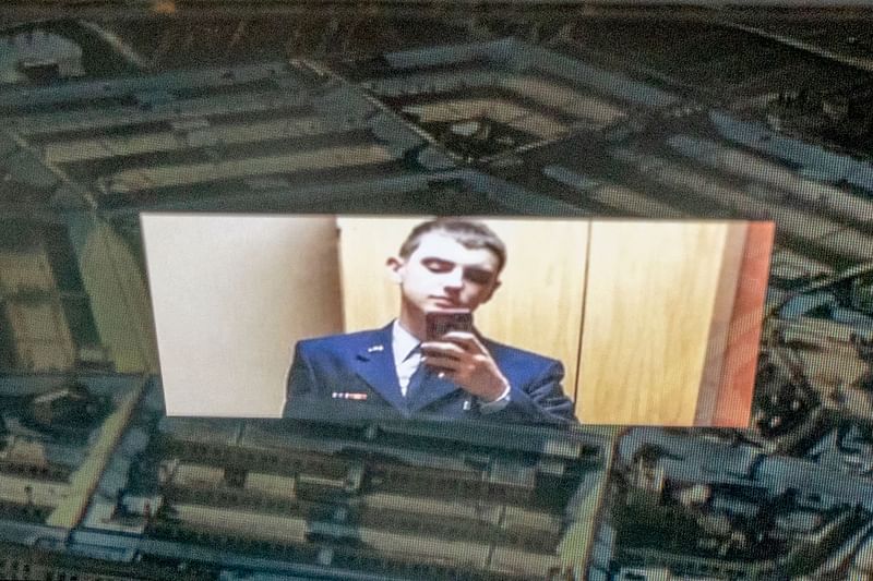 This photo illustration created on 13 April, 2023, shows the suspect, national guardsman Jack Teixeira, reflected in an image of the Pentagon in Washington, DC