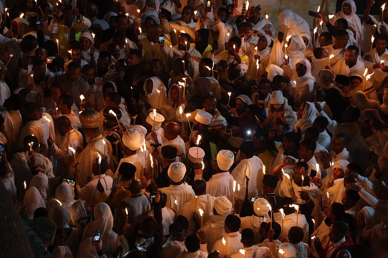 Ethiopian Orthodox Christian pilgrims hold candles during a ceremony of the "Holy Fire" at the Deir Al-Sultan Monastery on the roof of the Holy Sepulchre Church in Jerusalem's Old City on April 15, 2023, on the eve of Orthodox Easter