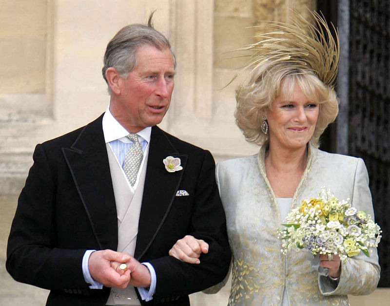 In this file photo taken on April 9, 2005 Prince Charles and Camilla, the Duchess of Cornwall leave a blessing at St Georges Chapel in Windsor Castle after their civil wedding