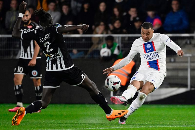 Paris Saint-Germain's French forward Kylian Mbappe fights for the ball during the French L1 football match between SCO Angers and Paris Saint-Germain (PSG) at The Raymond-Kopa Stadium in Angers, western France on 21 April, 2023