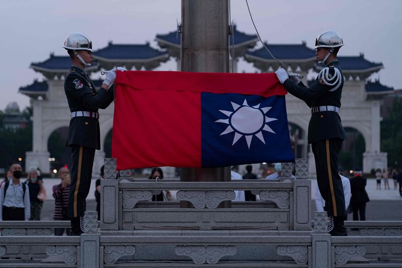 This photo taken on April 14, 2023 shows Taiwanese soldiers begining a flag-lowering ceremony in Liberty Square in Taipei. At a barbed-wire Taipei museum where political prisoners were once held for decades, visitors laud Taiwan's modern-day democracy that is shaping a national identity on the island across from authoritarian China