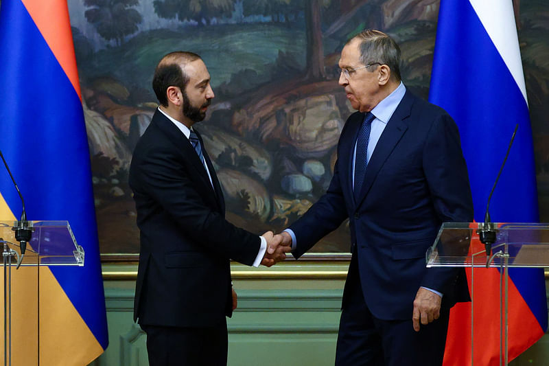 Russian Foreign Minister Sergei Lavrov and his Armenian counterpart Ararat Mirzoyan shake hands during a news conference following their talks in Moscow, Russia, March 20, 2023