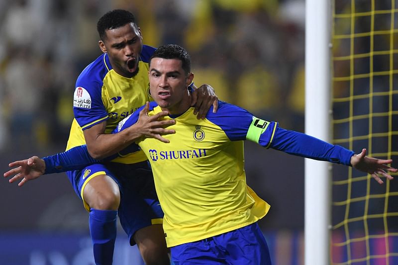 Al-Nassr's Portuguese forward Cristiano Ronaldo celebrates scoring his team's first goal during the Saudi Pro League match between Al-Nassr and Al-Raed at the al-Awwal Park Stadium in the Saudi capital Riyadh on 28 April 2023