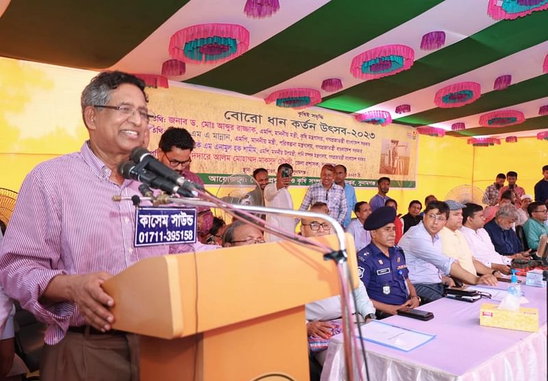 Agriculture minister M Abdur Razzaque speaking at a paddy harvesting festival and view-exchange meeting with the farmers at Dekar Hoar under Shantiganj upazila on Wednesday.