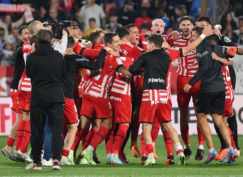 Girona players celebrate their 4-2 win after the Spanish league football match between Girona FC and Real Madrid CF at the Montilivi stadium in Girona on 25 April, 2023