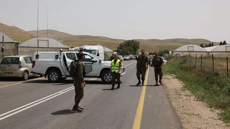 Israeli forces walk near the Hamra junction, in the northern part of the Jordan valley in the occupied West Bank, after the Israeli army closed it following a shooting attack on 7 April 2023.