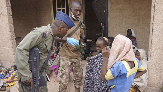 A Nigerian military officer talks with women and children who were freed from Boko Haram, in Yola state, in this April 29, 2015 handout image