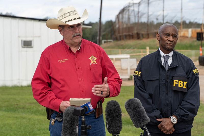 San Jacinto County Sheriff Greg Capers and Special Agent in Charge of the FBI Houston James Smith speak to the media near the crime scene where five people, including an 8-year-old child, were killed after a shooting inside a home on 29 April, 2023 in Cleveland, Texas