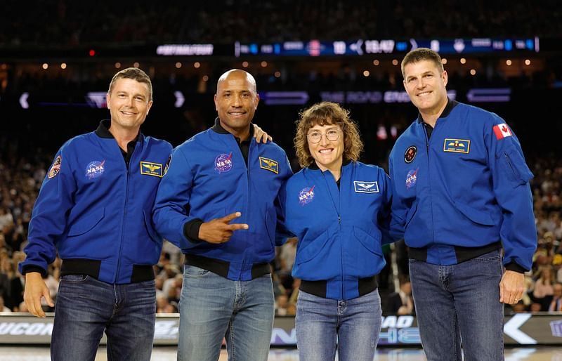 Astronauts Jeremy Hansen, Christina Koch, Victor Glover, and Reid Wiseman on the court prior to the game between the San Diego State Aztecs and Connecticut Huskies during the NCAA Men's Basketball Tournament National Championship game at NRG Stadium on 3 April, 2023 in Houston, Texas