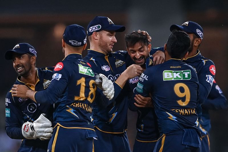 Gujarat Titans' players celebrate after winning the Indian Premier League match between Lucknow Super Giants and Gujarat Titans at the Ekana Cricket Stadium in Lucknow on 22 April 2023