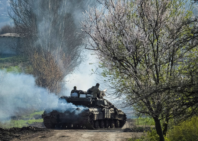 Ukrainian service members ride a tank, as Russia's attack on Ukraine continues, near the front line city of Bakhmut, Ukraine April 10, 2023