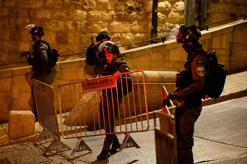 Israeli border policemen set up a fence near Al-Aqsa compound also known to Jews as the Temple Mount, while tension arises during clashes with Palestinians in Jerusalem's Old City, April 5, 2023