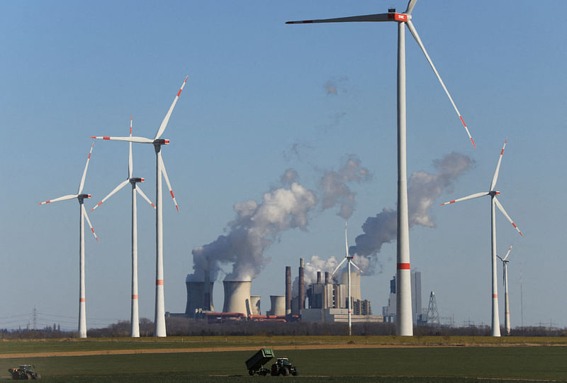 Wind power stations of German utility RWE, one of Europe's biggest electricity companies are pictured in front of RWE's brown coal fired power plants of Neurath, Germany, 18 March, 2022.