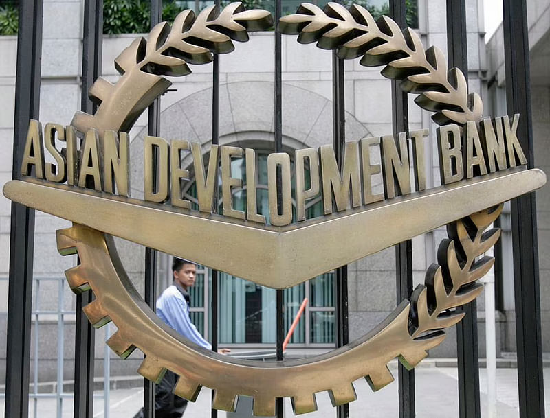 A worker walks past inside the Asian Development Bank (ADB) headquarters in Manila on 17 June, 2009.