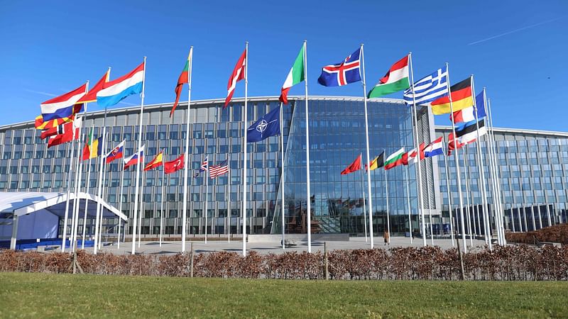 A photo shows member country flags with one empty mast ahead of a flag-raising ceremony for Finland’s accession to NATO, in the Cour d’Honneur of the NATO headquarters in Brussels, on 4 April, 2023