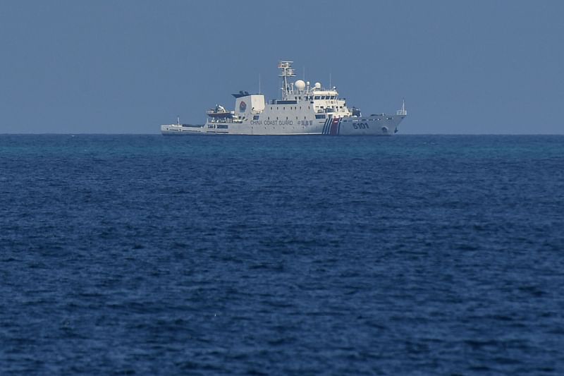 In this file photo taken on April 20, 2023, a Chinese coast guard ship patrols near the Philippine-occupied Thitu island in the disputed South China Sea